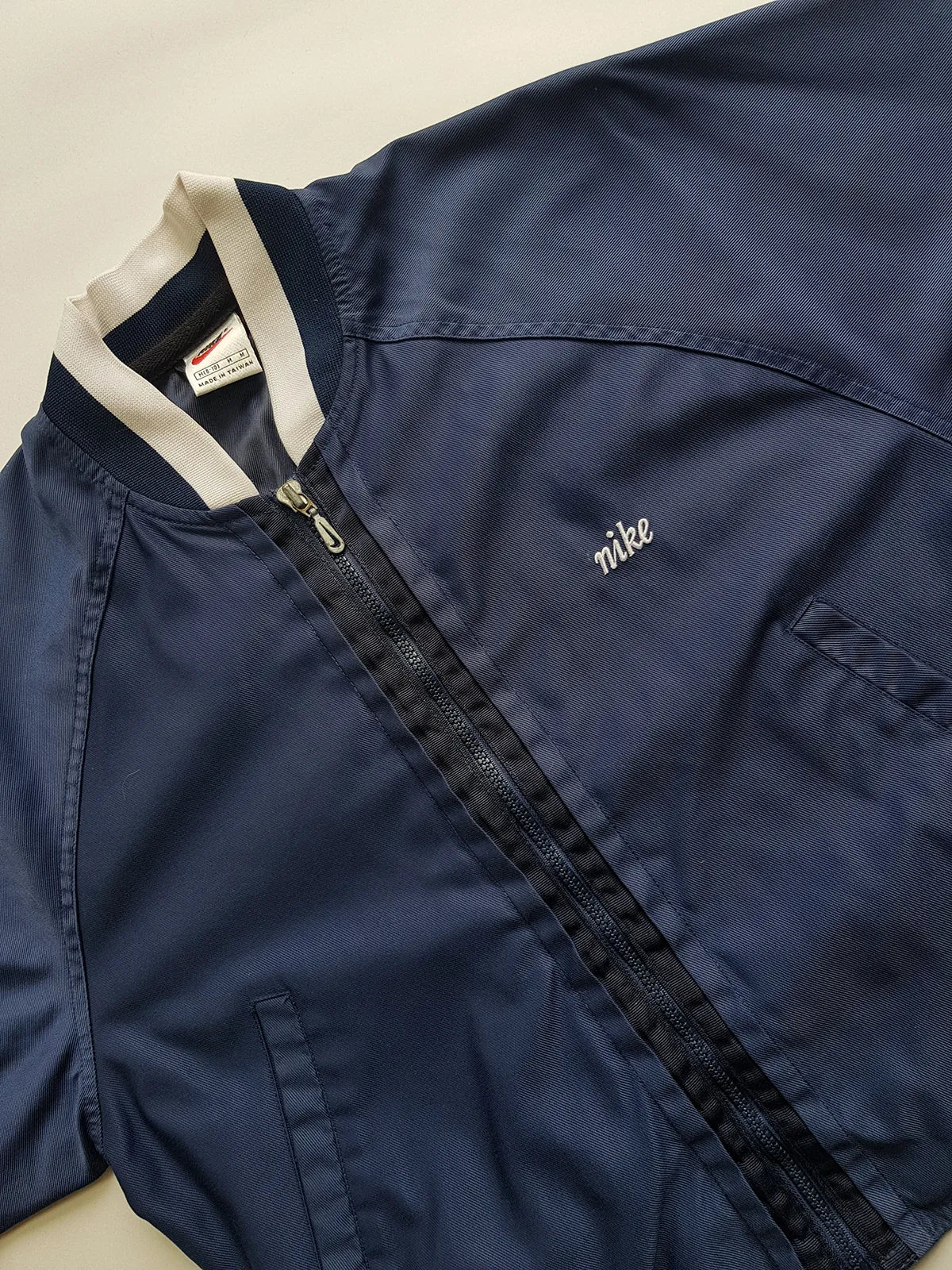 1990s Vintage Authentic Nike Workwear Vibes -  Bomber Style Track Jacket - Navy & Vintage White - Silver Hardware & Big Chunky Metal Zip - Embroidered Nike on the Chest - Elasticated Paneling on Neck Waist & Sleeves - Unworn Condition - Unisex Fit