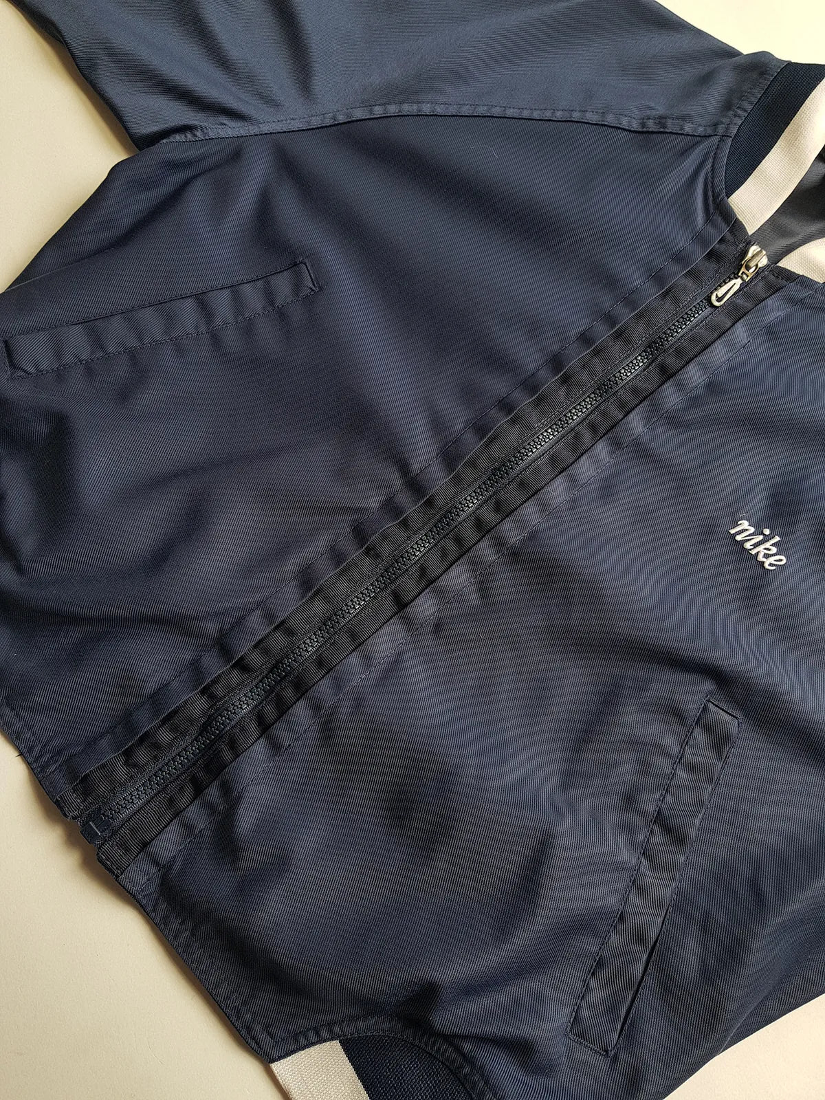 1990s Vintage Authentic Nike Workwear Vibes -  Bomber Style Track Jacket - Navy & Vintage White - Silver Hardware & Big Chunky Metal Zip - Embroidered Nike on the Chest - Elasticated Paneling on Neck Waist & Sleeves - Unworn Condition - Unisex Fit