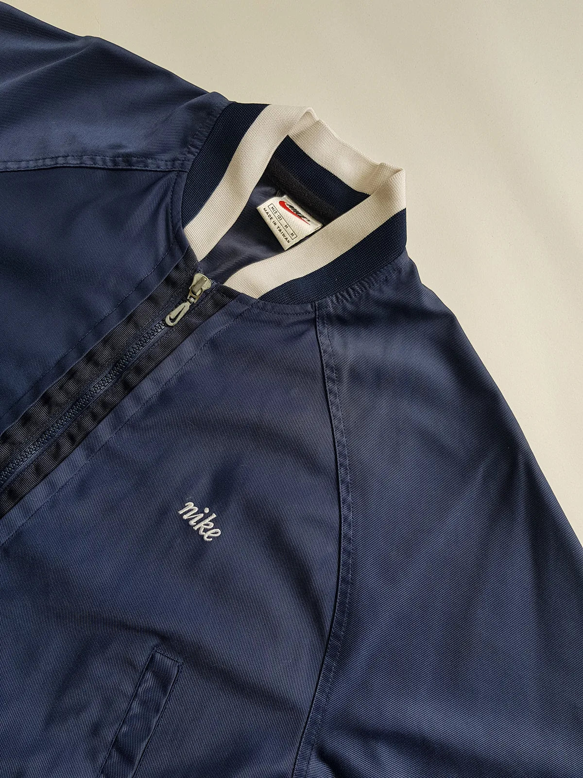 1990s Vintage Authentic Nike Workwear Vibes -  Bomber Style Track Jacket - Navy & Vintage White - Silver Hardware & Big Chunky Metal Zip - Embroidered Nike on the Chest - Elasticated Paneling on Neck Waist & Sleeves - Unworn Condition - Unisex Fit