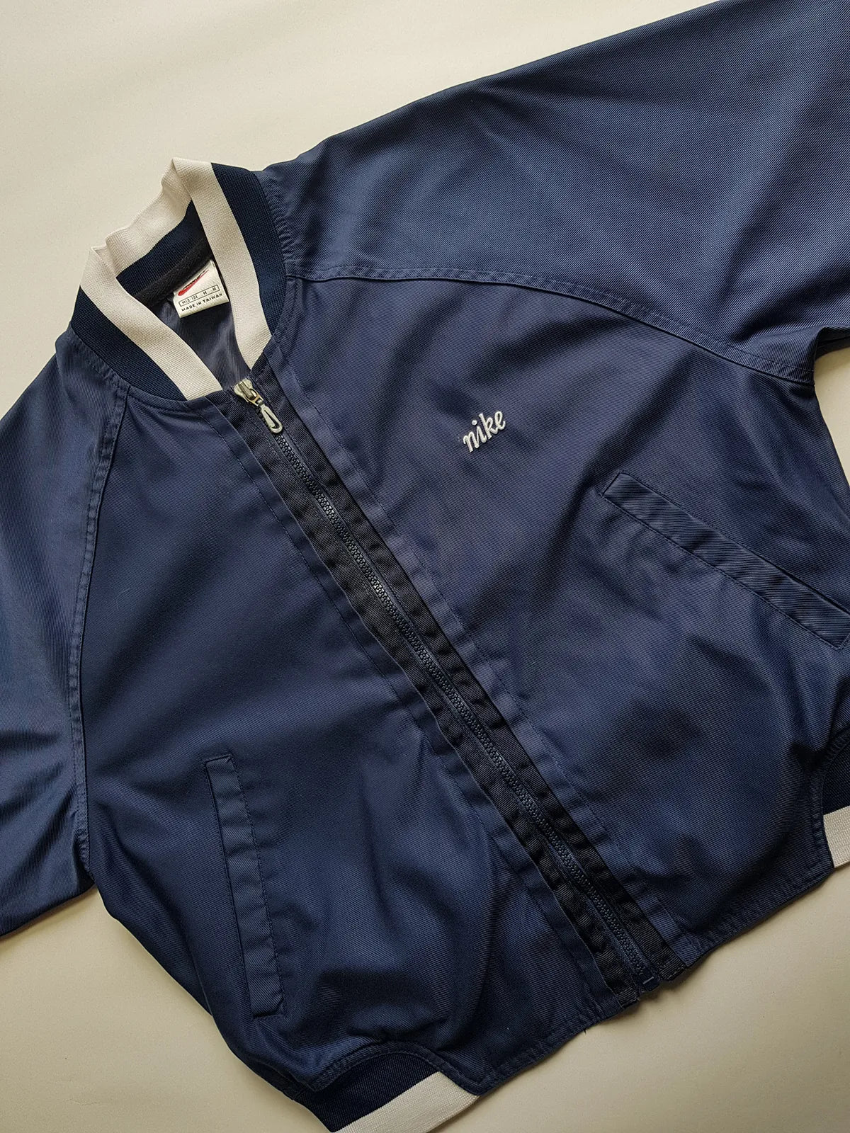 1990s Vintage Authentic Nike Workwear Vibes -  Bomber Style Track Jacket - Navy & Vintage White - Silver Hardware & Big Chunky Metal Zip - Embroidered Nike on the Chest - Elasticated Paneling on Neck Waist & Sleeves - Unworn Condition - Unisex Fit