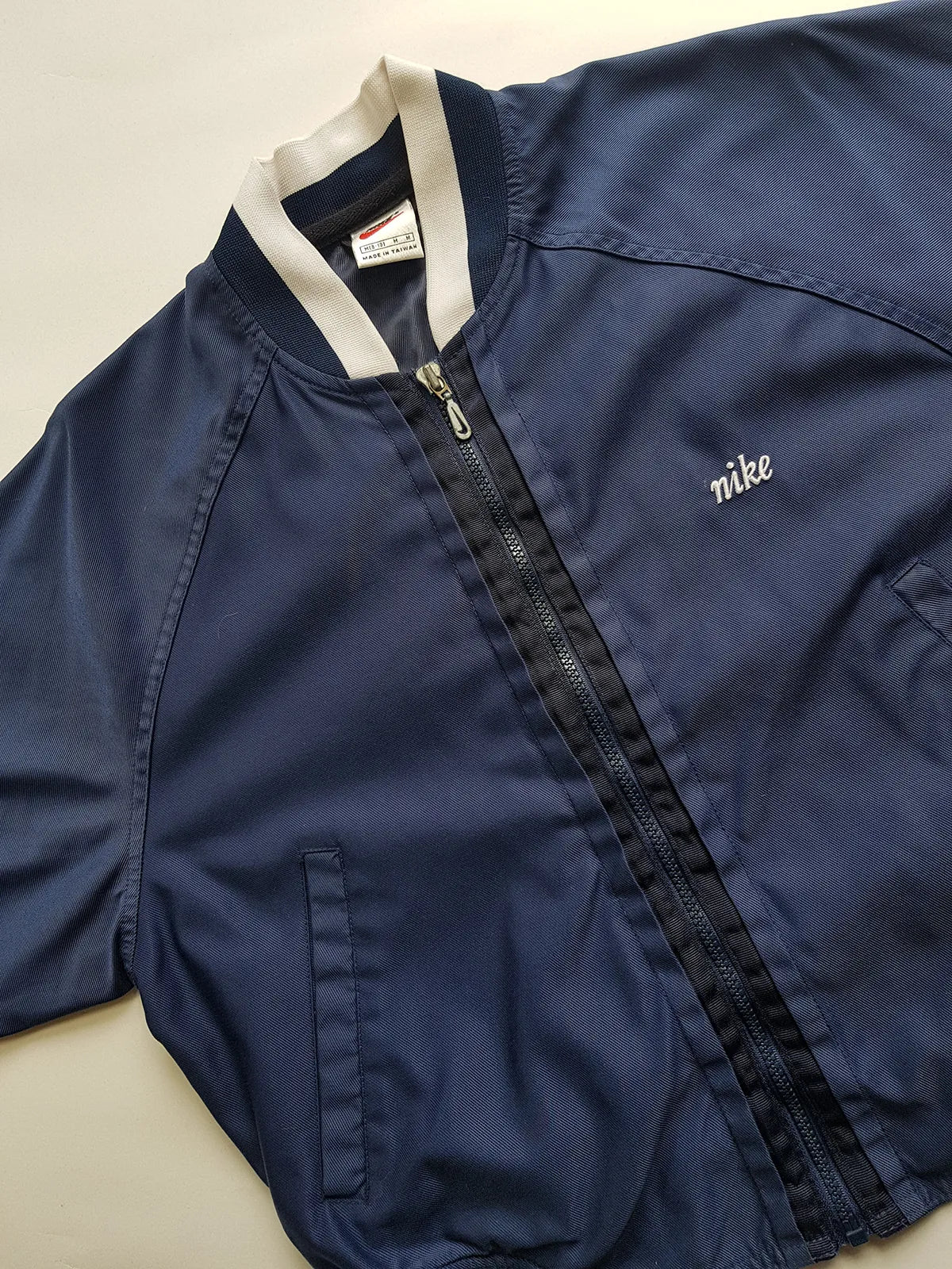 1990s Vintage Authentic Nike Workwear Vibes -  Bomber Style Track Jacket - Navy & Vintage White - Silver Hardware & Big Chunky Metal Zip - Embroidered Nike on the Chest - Elasticated Paneling on Neck Waist & Sleeves - Unworn Condition - Unisex Fit
