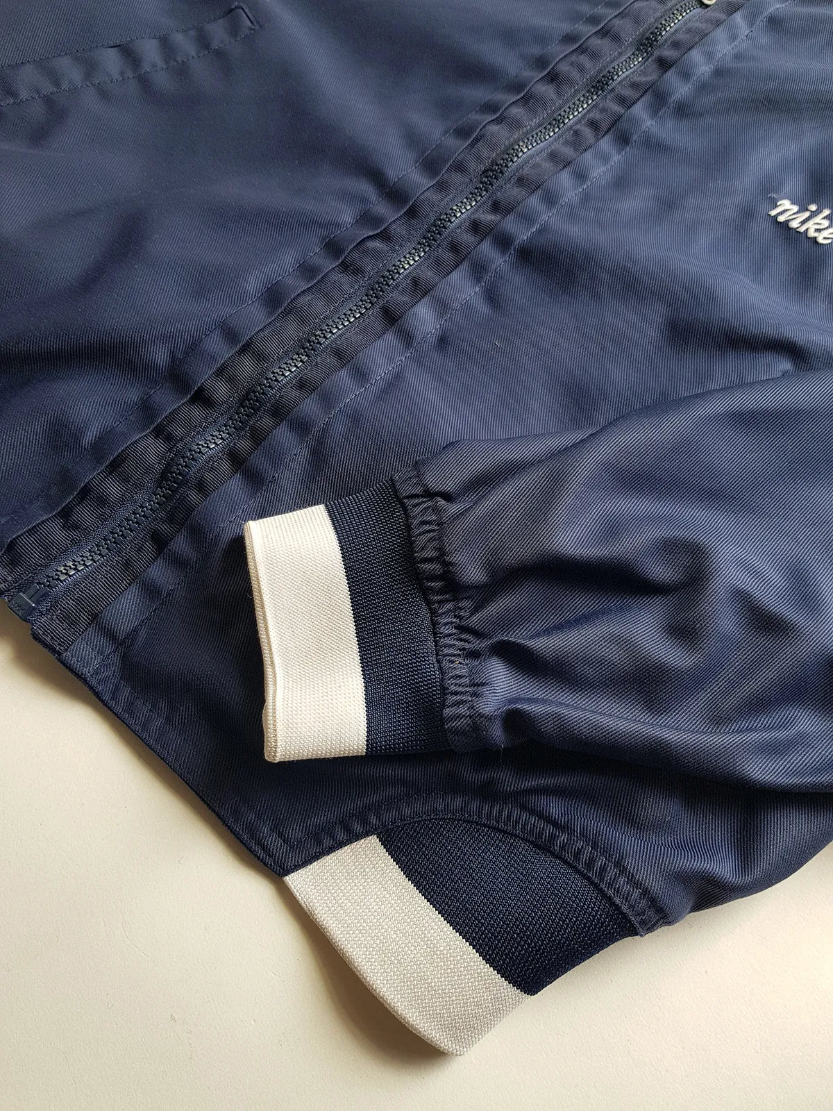 1990s Vintage Authentic Nike Workwear Vibes -  Bomber Style Track Jacket - Navy & Vintage White - Silver Hardware & Big Chunky Metal Zip - Embroidered Nike on the Chest - Elasticated Paneling on Neck Waist & Sleeves - Unworn Condition - Unisex Fit